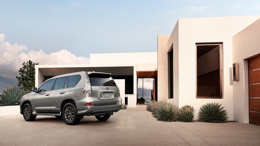 A gray 2022 Lexus GX460 parked in front of a house.