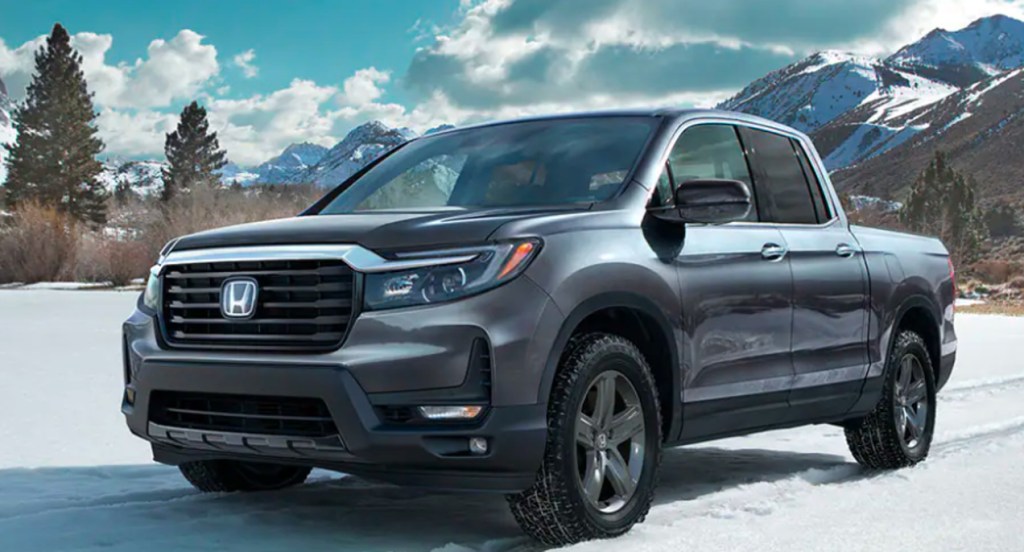 A gray 2022 Honda Ridgeline is parked in the snow. 
