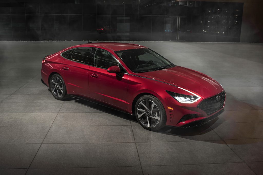 An overhead view of a red 2022 Hyundai Sonata parked on a concrete lot in front of a building
