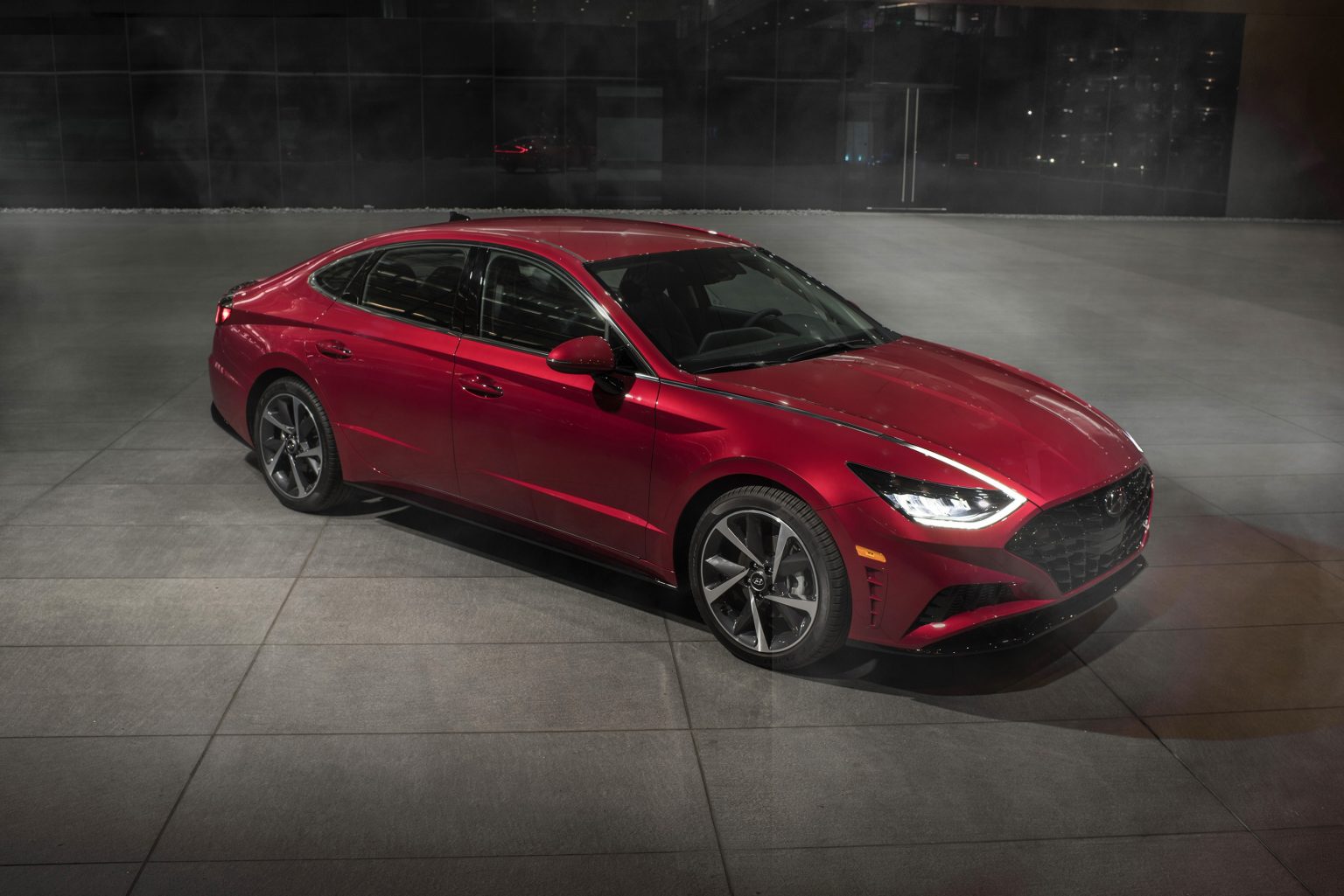 An overhead view of a red 2022 Hyundai Sonata parked on a concrete lot in front of a building