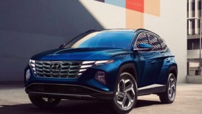 A blue 2022 Hyundai Tucson small plug-in hybrid SUV is parked outside.
