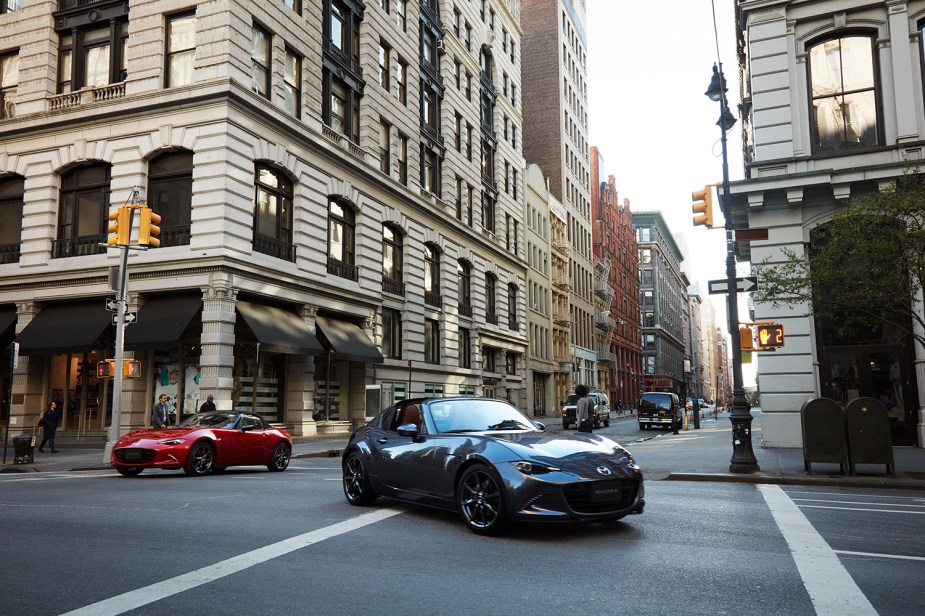Pair of 2022 Mazda MX-5 Miata Roadsters in street, the most reliabile sports car according to Cosumer Reports