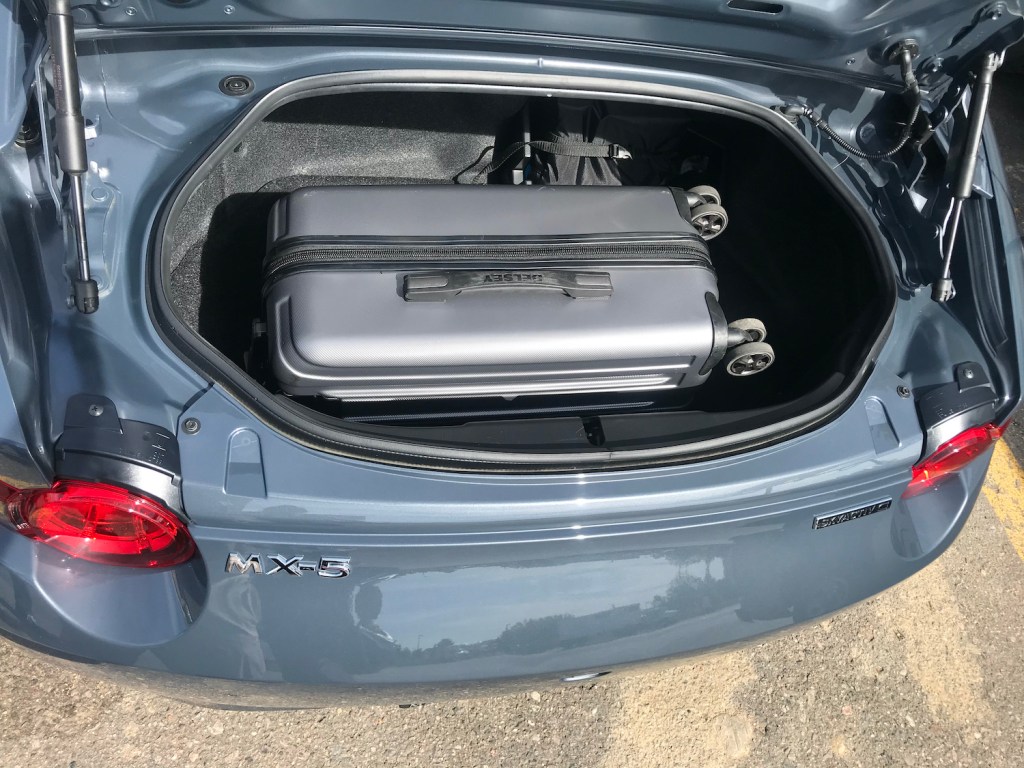 2022 Mazda MX-5 cargo space with a carry-on suitcase in it.