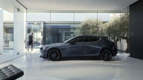 A 2022 Mazda3 hatchback model parked in an office space