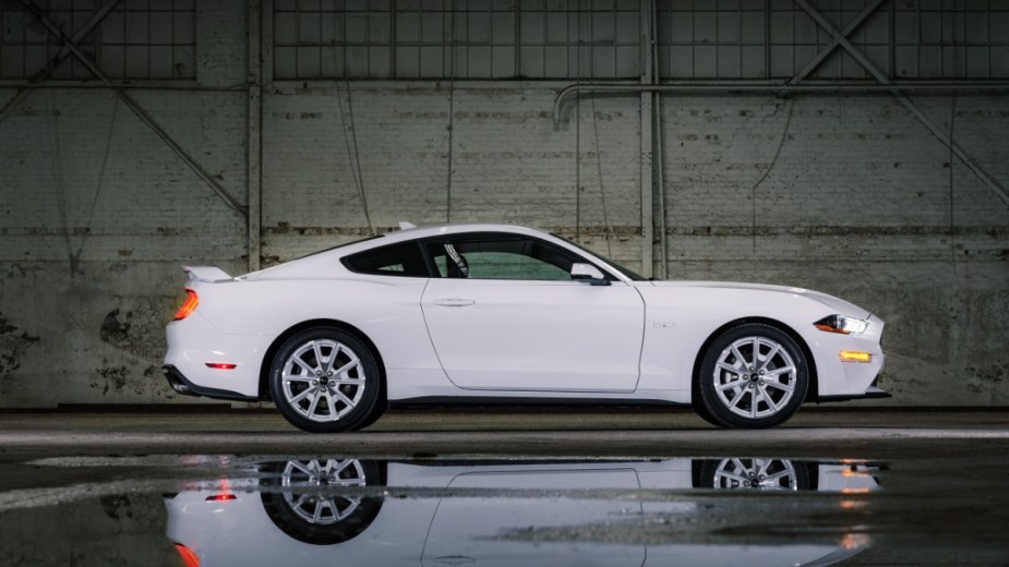 a white 2022 ford mustang parked in a warehouse