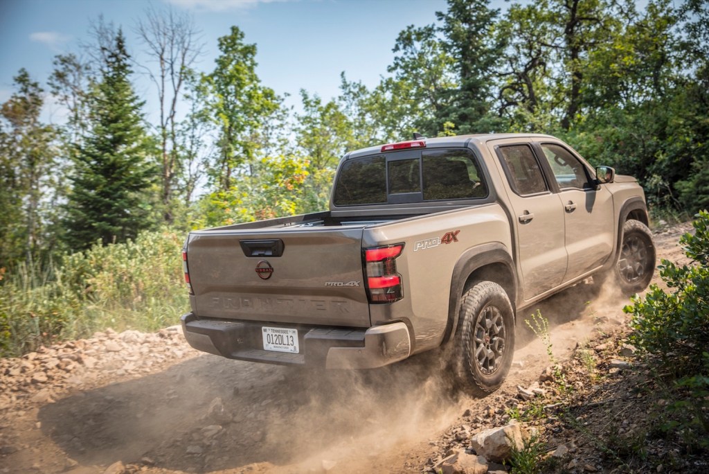 Nissan Frontier midsize pickup truck tackling an off-road trail.