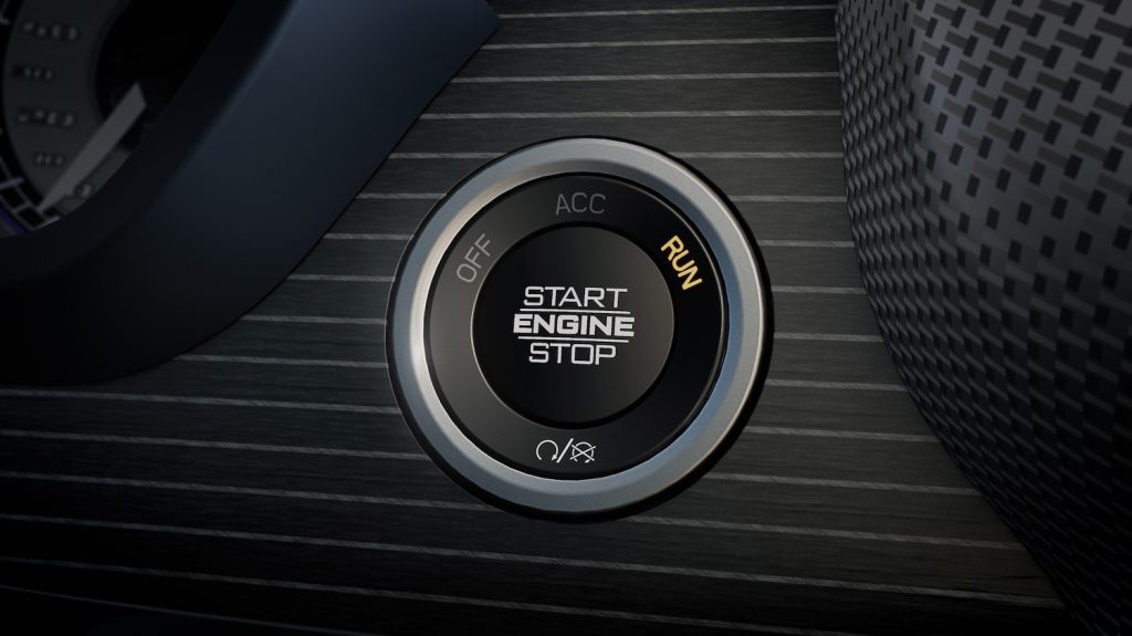 Detail shot of the engine start/stop button in a Ram pickup truck interior.