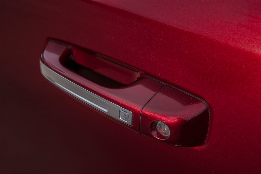 Door handle of a red pickup truck.