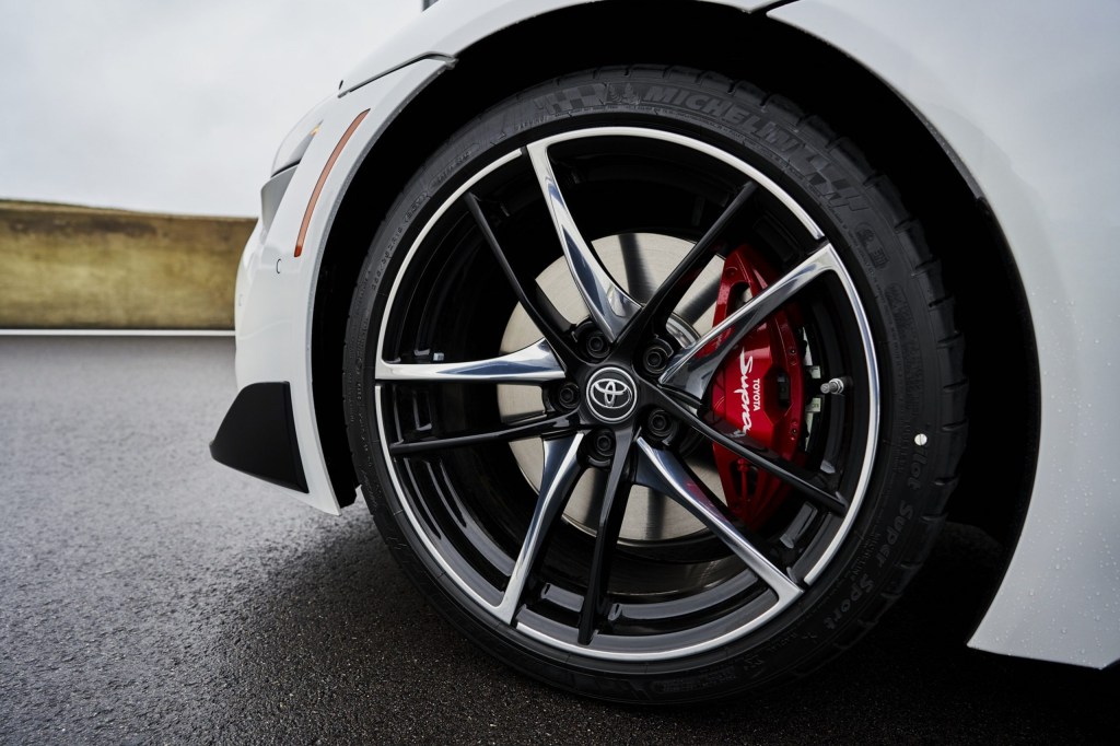 The Michelin Pilot Super Sport tire on the front of a white 2022 Toyota GR Supra 3.0 Premium