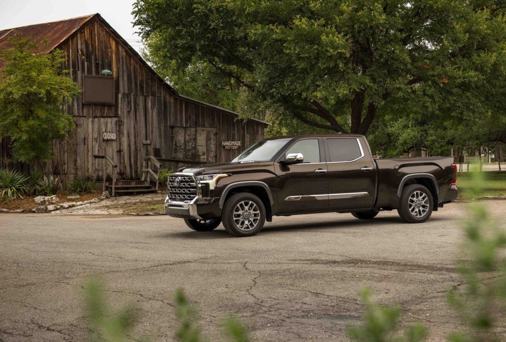 Promo photo of an American-made Toyota Tundra pickup truck parked next to an old barn.