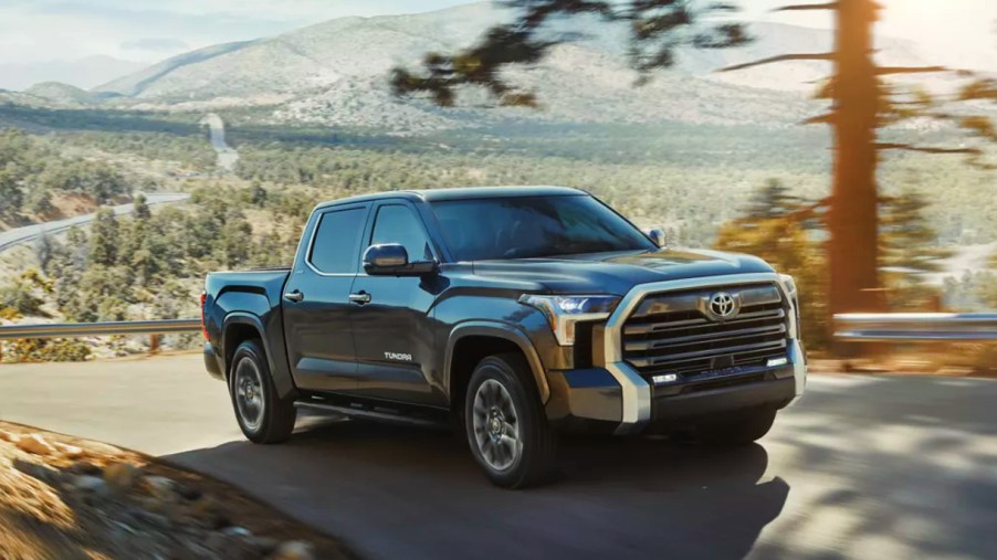 A gray 2022 Toyota Tundra full-size truck is driving on the road.