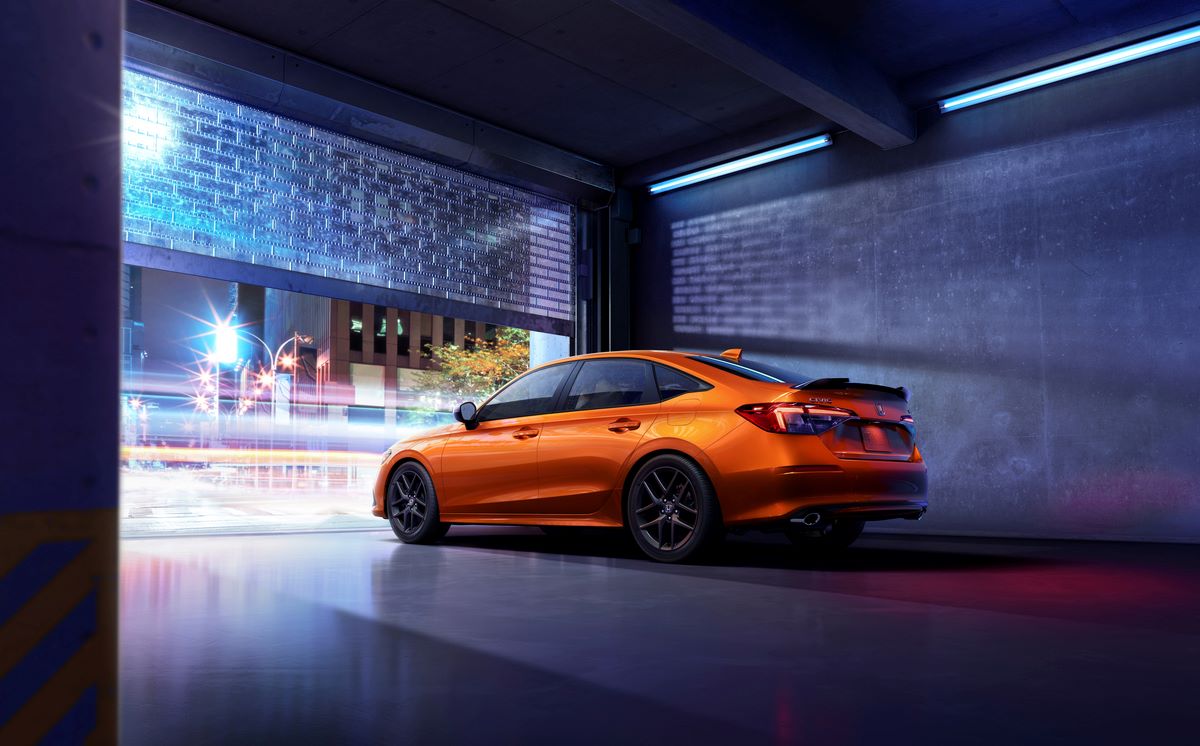 Bright orange 2022 Honda Civic Si hatchback, a major Acura Integra competitor