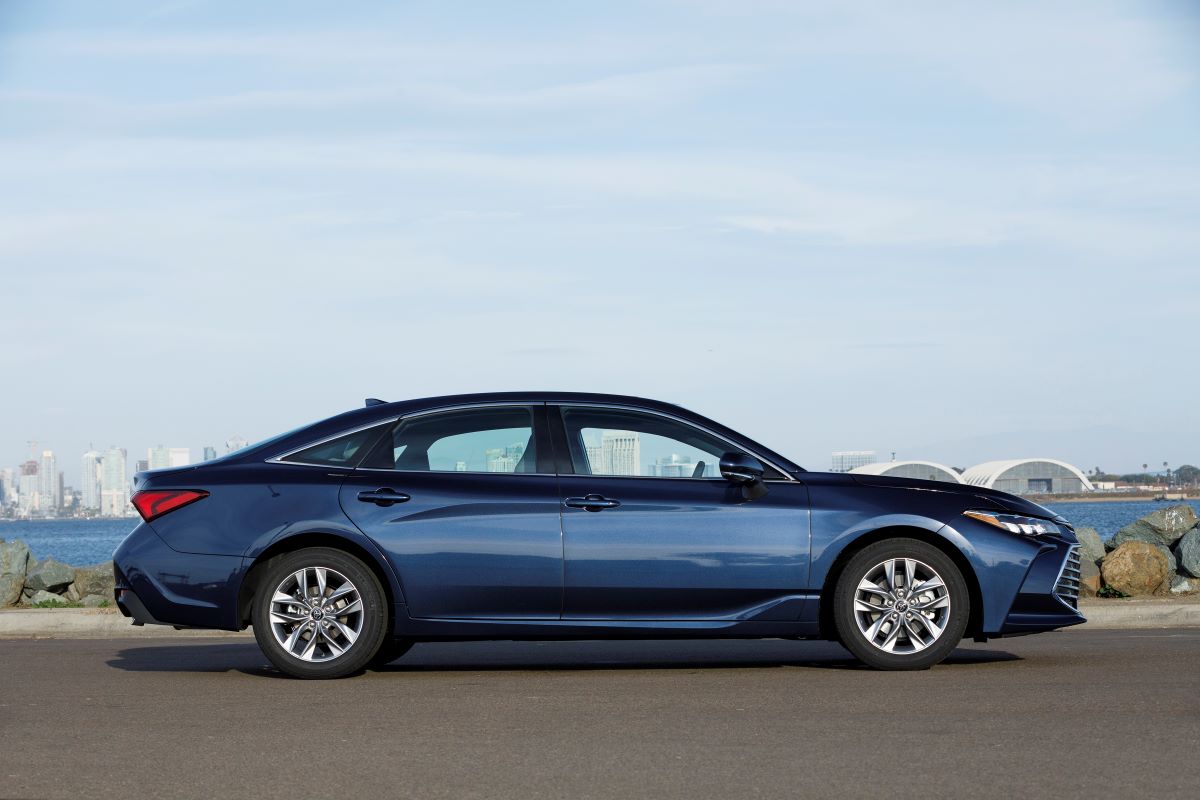 Side view of a blue Toyota Avalon full-size sedan, one of the last large four-door cars on the market