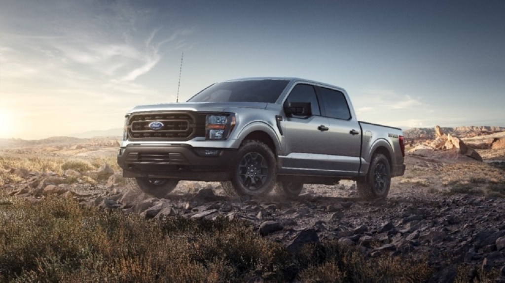 A silver 2023 Ford F-150 on a rocky hill.