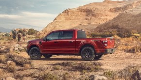 A red 2023 Ford F-150 in front of rocks.