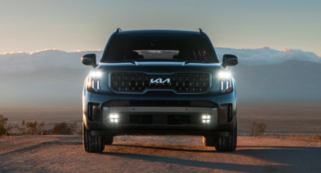 A  Jungle Wood Green 2023 Kia Telluride is parked outdoors. 