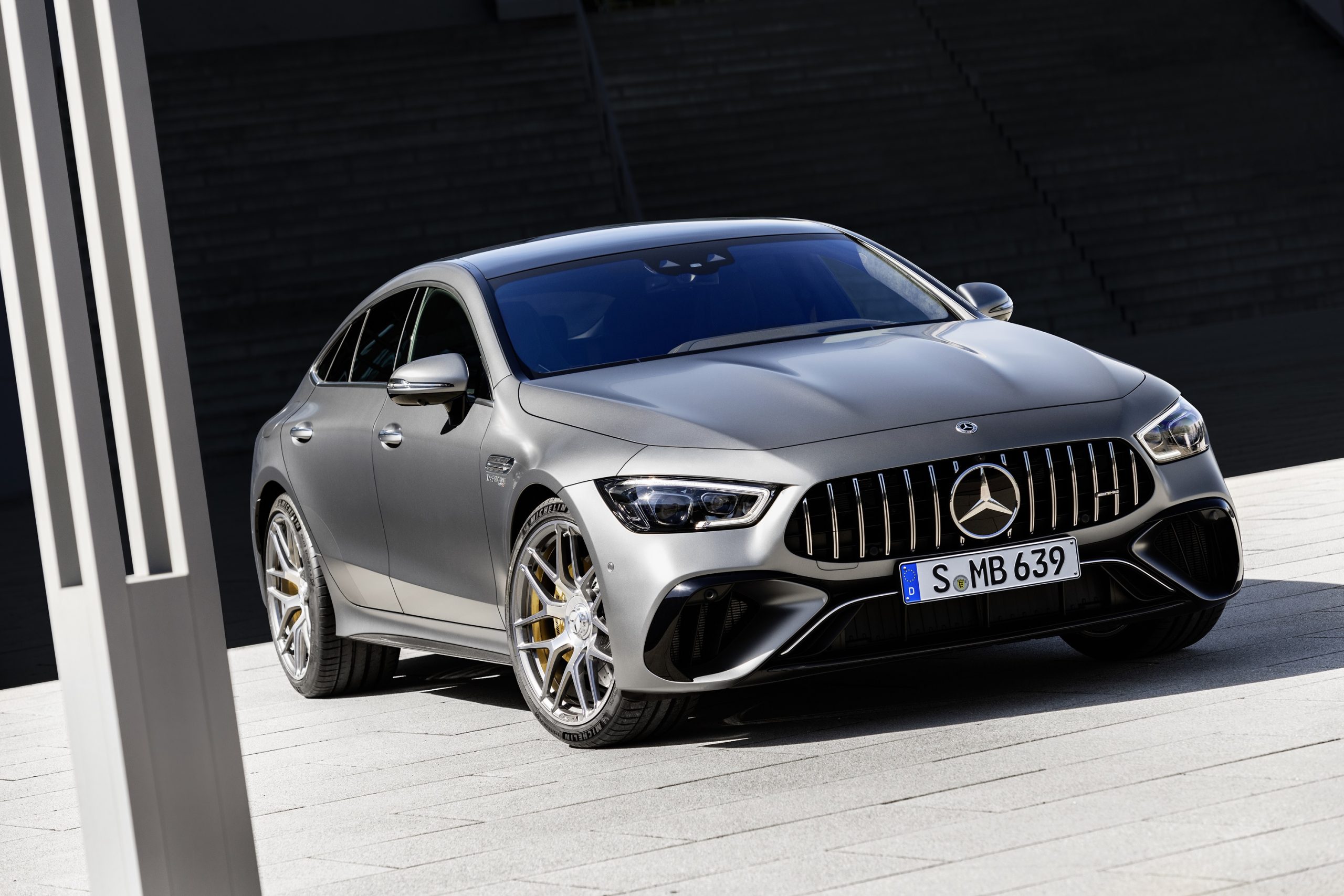 A matte-gray 2023 Mercedes-AMG GT 63 S by an office building