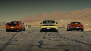 Heads up drag race between yellow 2023 Nissan Z automatic against red 2022 Ford Mustang Mach 1 and red 2022 Toyota GR Supra 3.0