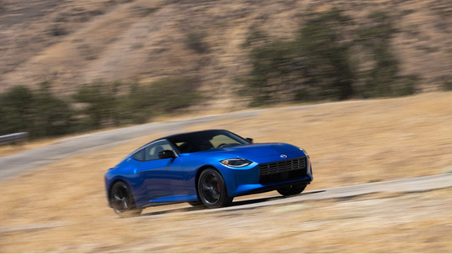 a blue 2023 nissan z carving up a canyon road