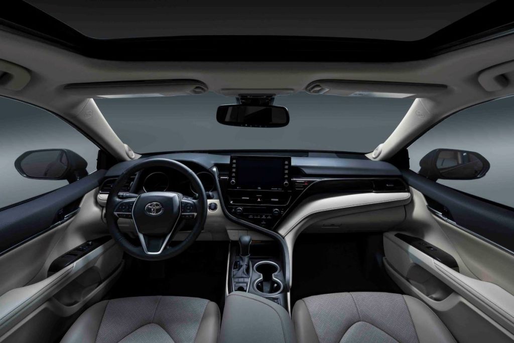 Interior of the 2022 Toyota Camry midsized sedan, looking forward from the front seats out through the windshield. The 2022 Toyota Camry should have an identical interior.