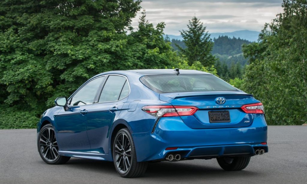 Rear angle view of a blue 2023 Toyota Camry XSE midsize sedan.