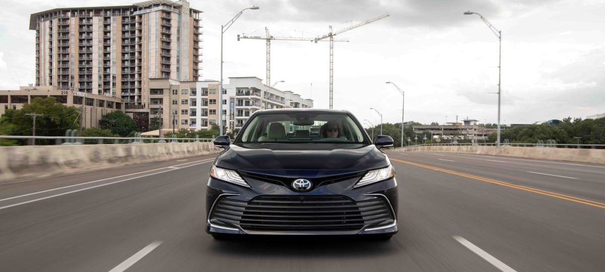 Frontal view of a black 2022 Toyota Camry midsize sedan; the style is sharp, but a 2023 redesign could make the Camry even more competitive