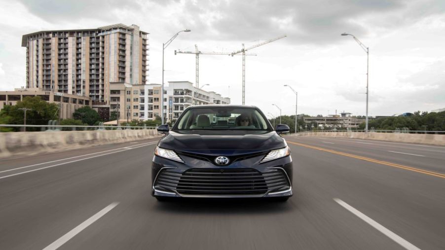 Frontal view of a black 2022 Toyota Camry midsize sedan; the style is sharp, but a 2023 redesign could make the Camry even more competitive