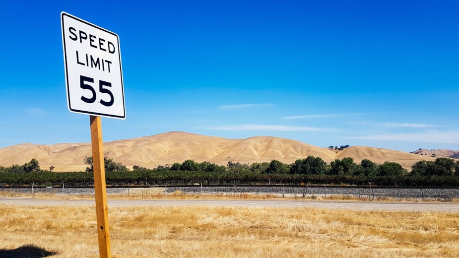 a speed limit sign in the desert which can help you save money and keep a full tank for longer