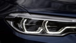 A dark-blue 2018 BMW M550i's full-LED adaptive headlights