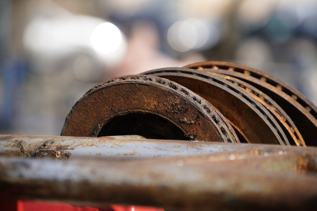 A stack of disc brake rotors covered in rust at a Kyiv scrapyard gym