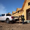 A white F-150 with workers using the Pro Power Onboard