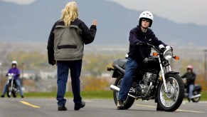 An instructor talks to a new rider at a motorcycle safety course run by A Brotherhood Active Towards Education in Colorado