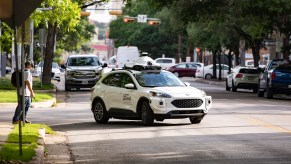 An Argo AI full self-driving taxi and delivery Ford Escape on public roads in Austin, Texas