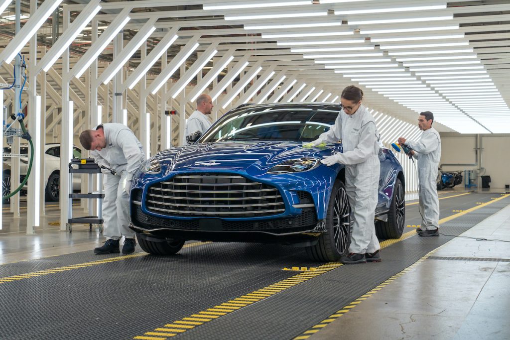 Factory workers inspect the first Aston Martin DBX 707 before being delivered to the customer.