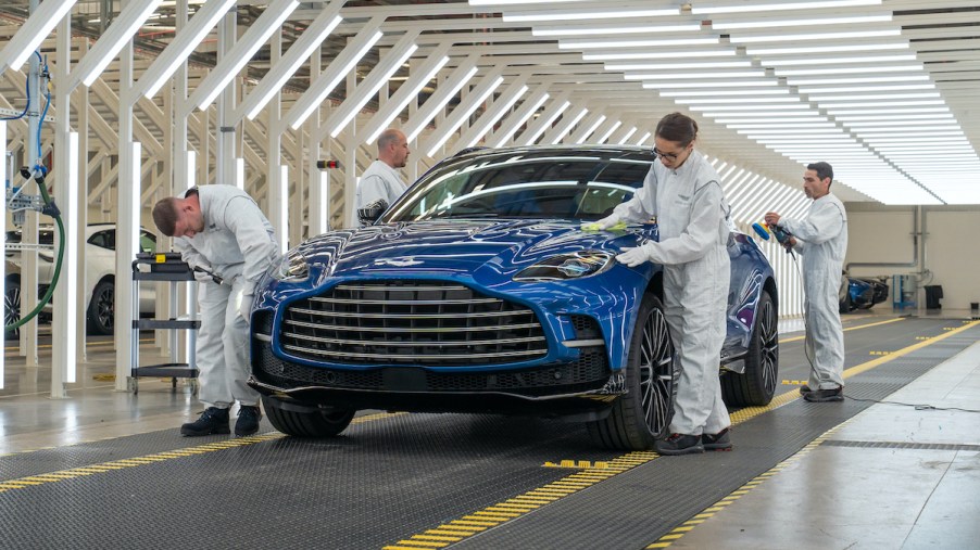 Factory workers inspect the first Aston Martin DBX 707 before being delivered to the customer.