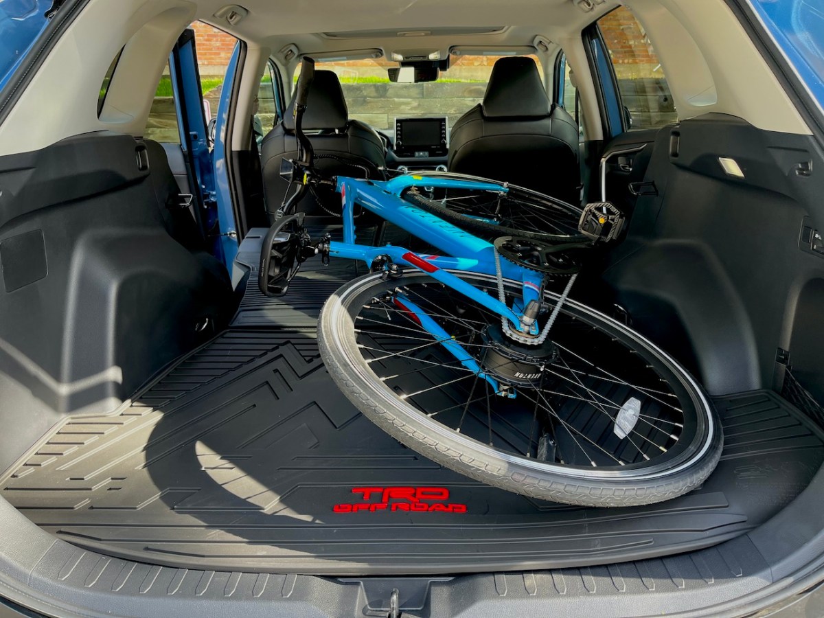 An Aventon electric bicycle stored in the luggage compartment of the 2022 Toyota RAV4.