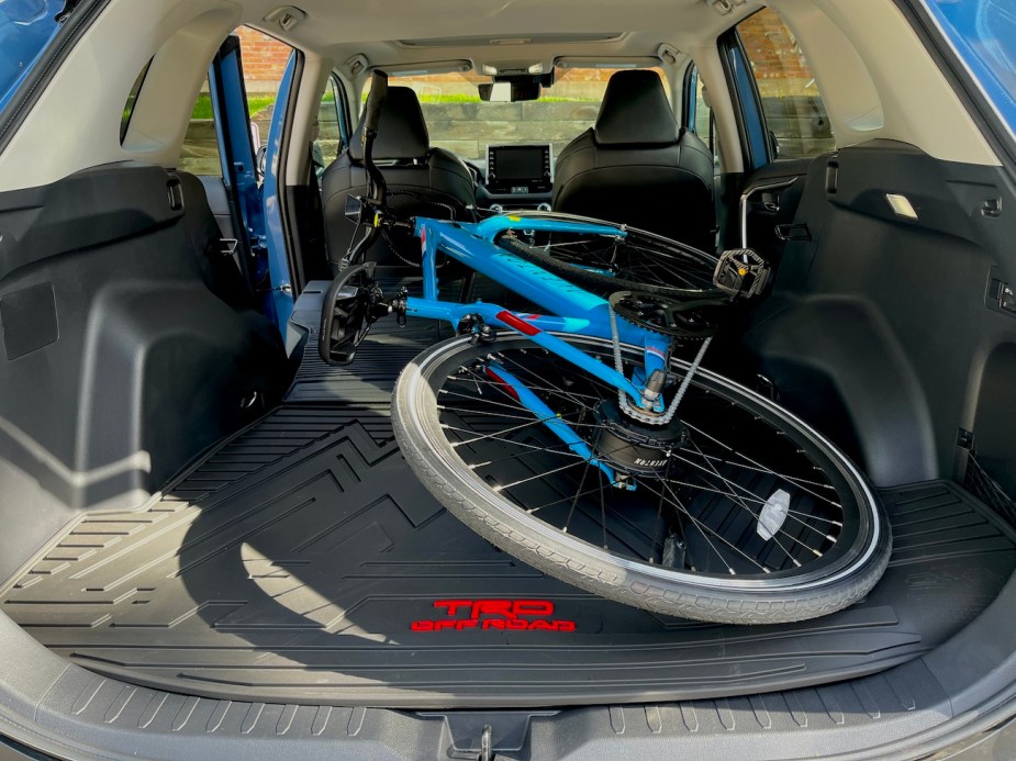 An Aventon electric bike stored in the cargo area of the 2022 Toyota RAV4.