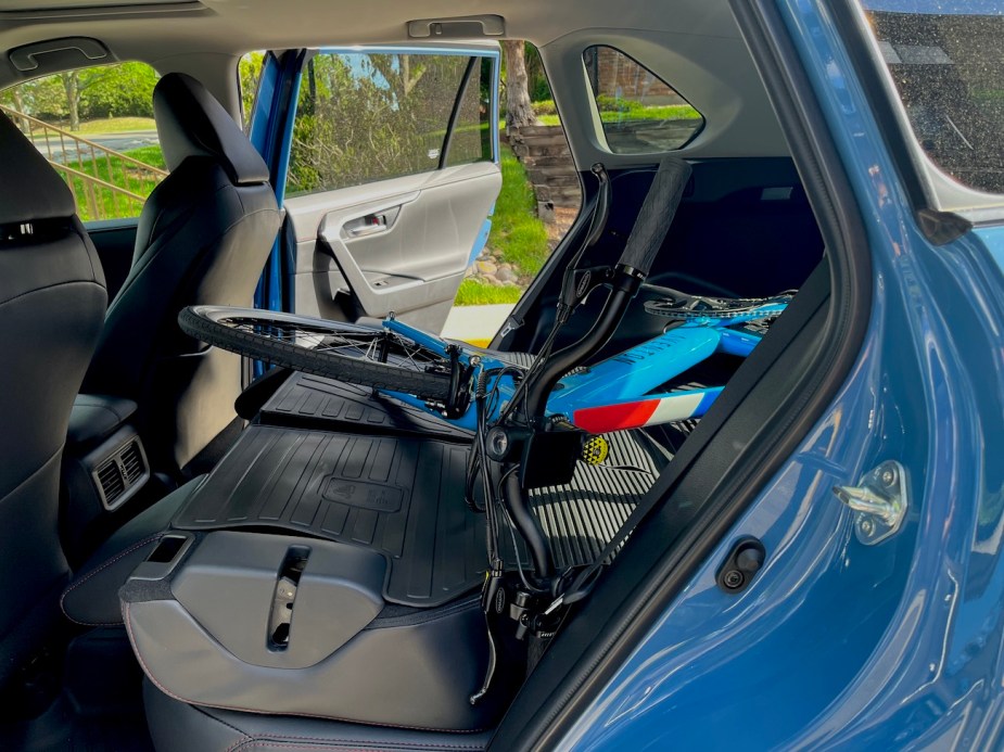 A side view of an e-bike sitting in the cargo area of the Toyota RAV4