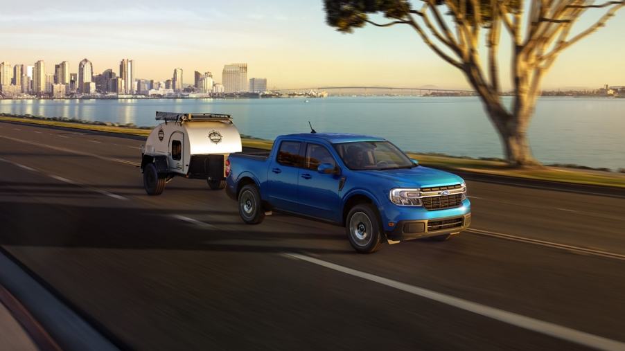 Blue 2022 Ford Maverick, the only new pickup truck that costs less than $20,000, towing a trailer