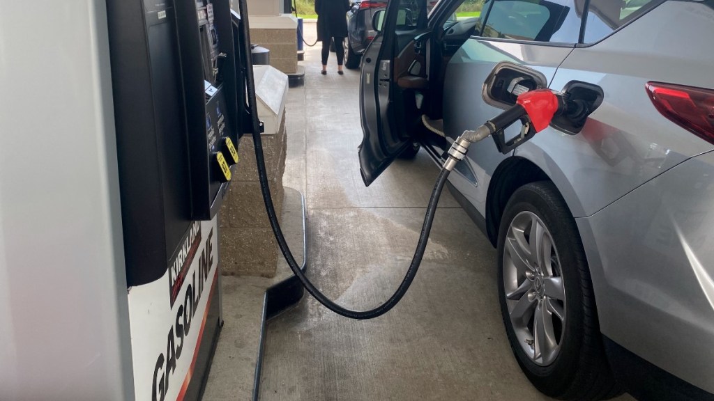 a car fueling up at a gas station
