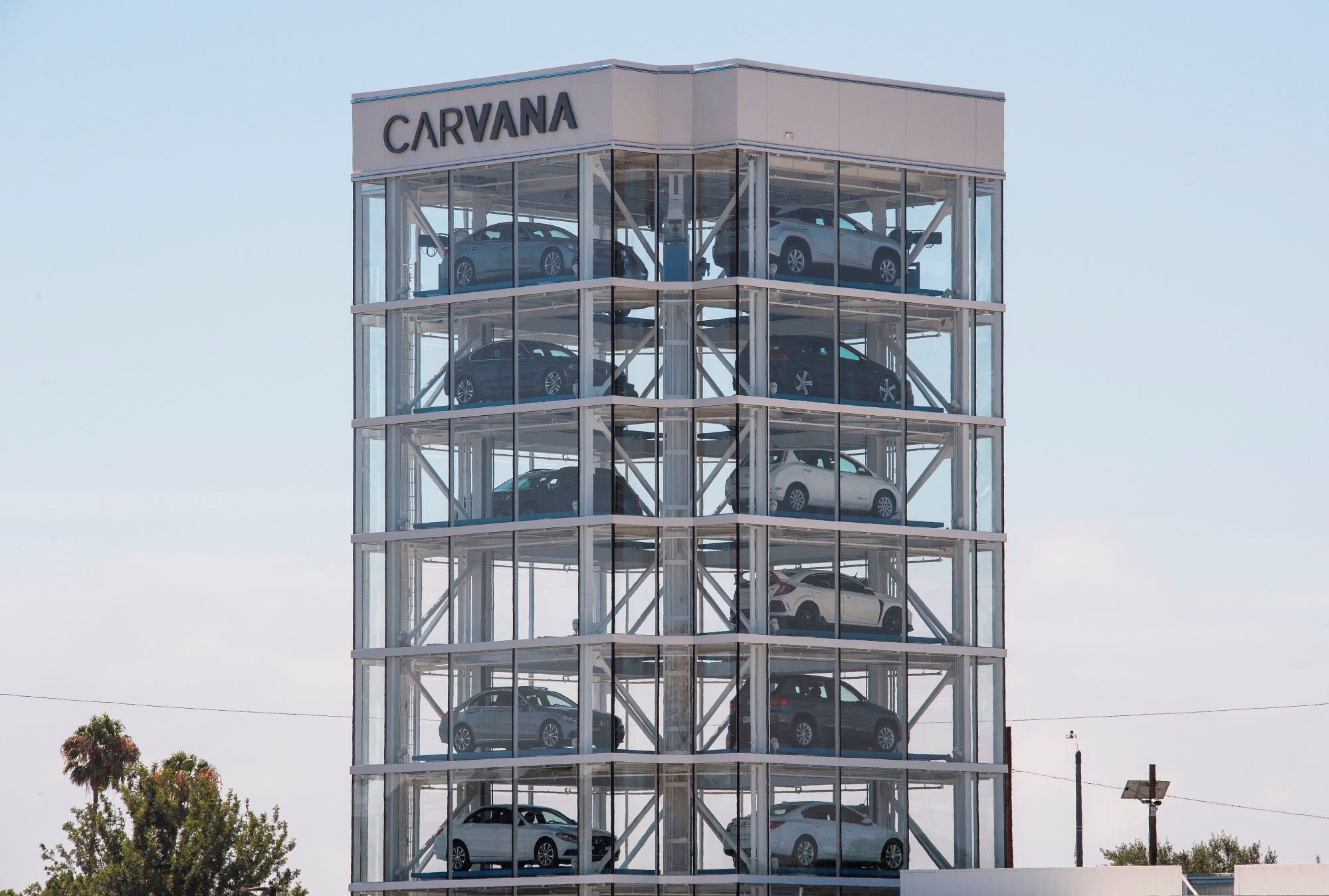 The Carvana building with multiple cars inside.