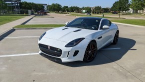 A ceramic-coated white 2015 Jaguar F-Type R Coupe in a sunny parking lot