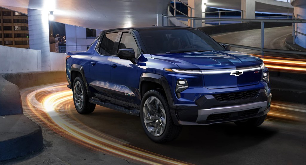 A blue 2024 Chevy Silverado EV RST blue electric pickup truck is driving.