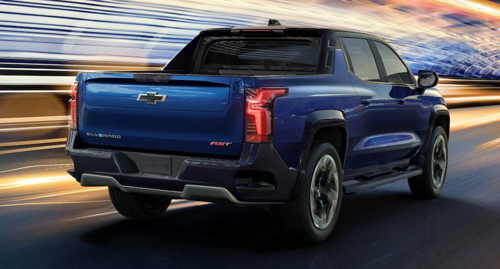 A blue 2024 Chevy Silverado EV RST electric pickup truck drives down the road. 