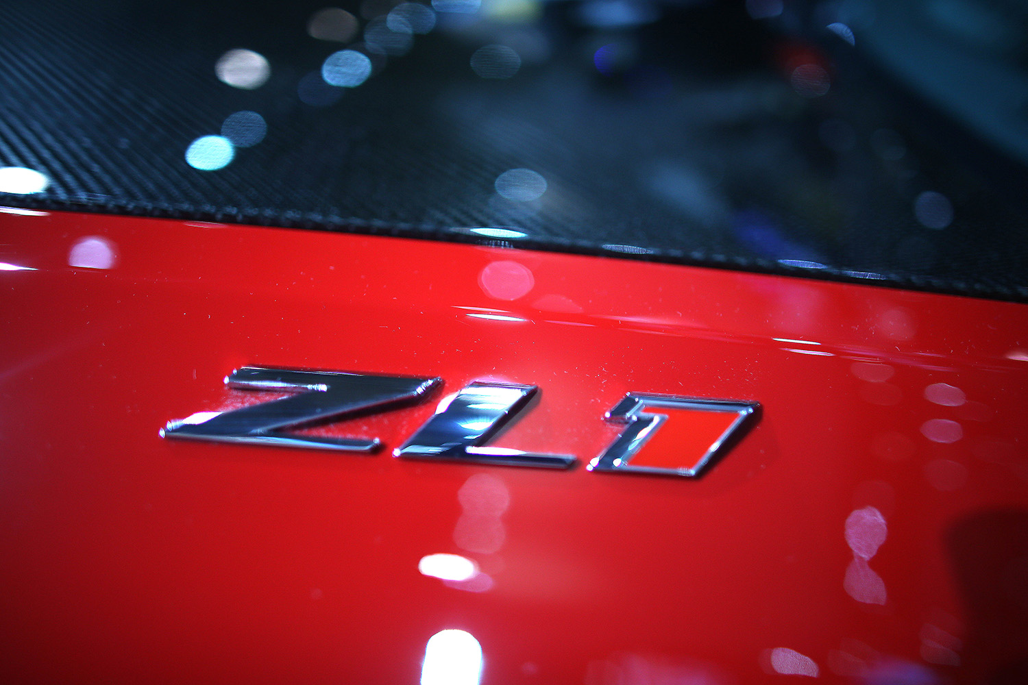 Closeup of ZL1 badge on 2013 Chevrolet Camaro In Red, same color as the cheapest one currently available for sale in the U.S.