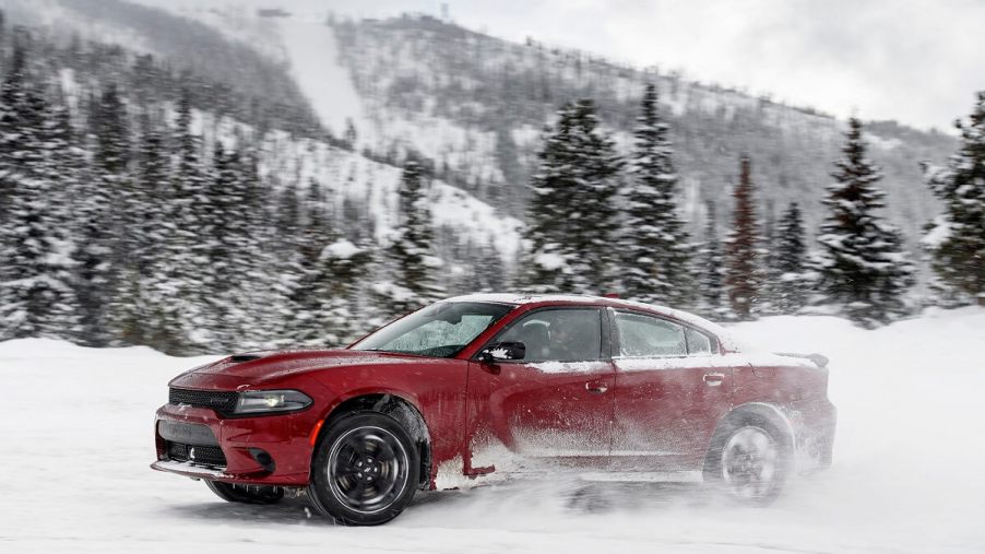A red Dodge Charger GT AWD kicks up snow.
