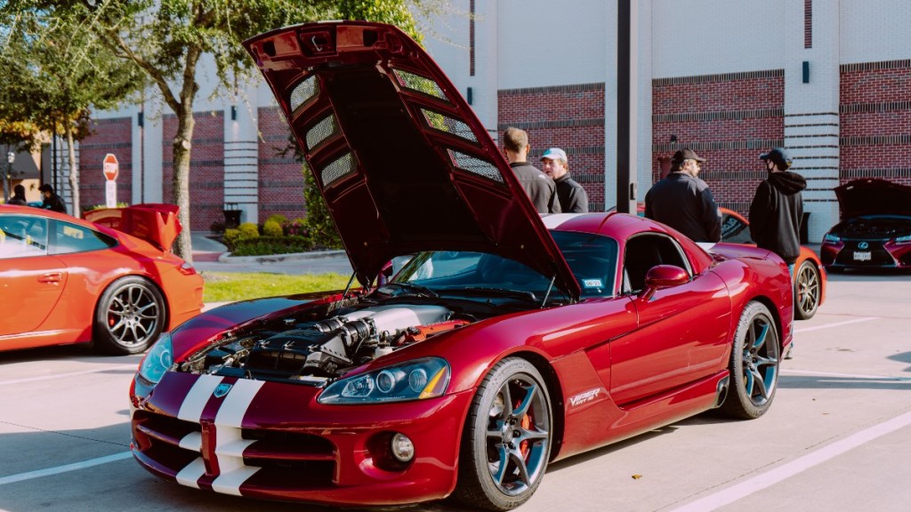 a dodge viper srt 10 with its hood open showing of its performance focused v10 engine
