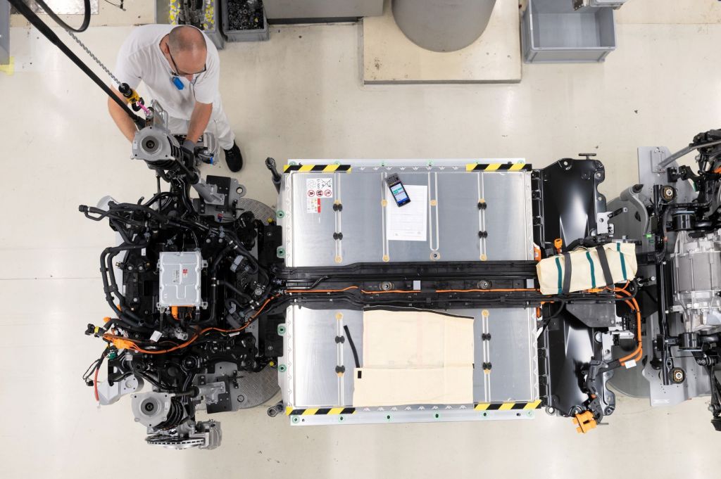 A person assembling and setting up EV batteries. 
