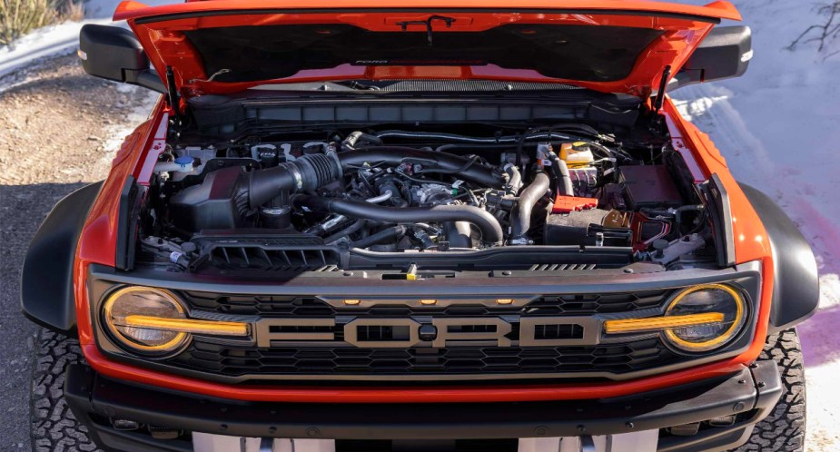 A red 2022 Ford Bronco Raptor off-road SUV's engine bay. 