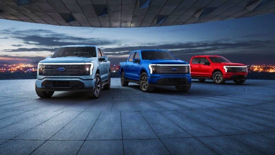 Ford F-150 Lightnings lined up in a garage